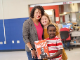 Dalla Emerson, food-service director for the Bowling Green Independent Schools, is congratulated by, from right, Wilondja Akili and Quinn Otto after General Mills honored her school-nutrition work by putting her photo on a Wheaties box. The students serve