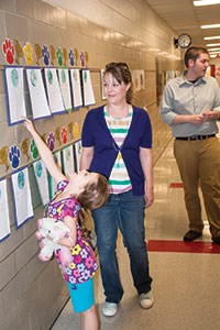 First-grader Reagan Boone-Menke points out some of her work about Earth Day to her mother, Rachel Boone. Ludlow Schools Superintendent Mike Borders said one goal of the evening was to get younger students and their parents into the school to see the other artistic studies opportunities available in the upper grades.