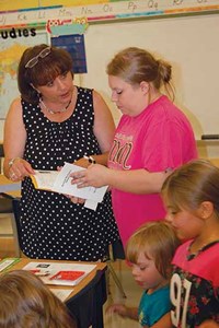 At the K-3 Campbell Elementary, second-grade teacher Jennifer Beek helps parent Kelli Johnson with some of the back-to-school paperwork. Principal Jill Imes said the event has helped ease some of the jitters for young students and answers questions for parents, avoiding confusion when classes begin.