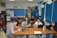 Students in Tiffany Burchett’s eighth-grade English class work on reading assignments on digital devices. The students, in the foreground from l-r, are Gabe Stepp, Samarra Howell, Bryce Ward and Jay Wiley.
