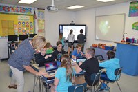 Students in Stephanie Tiller’s fifth-grade math class use a Chromebook to work on assignments while other students do math problems on a MondoPad.
