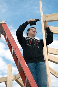 Deklan Osborne anchors the top of one 15-foot tower bridge for the gazebo going up next to the ATC. In addition to the carpentry students, electrical class members are wiring both facilities so students can use laptops and other electrical devices at each site. Eventually community members will be able to use the gazebos for special events when school is not in session.