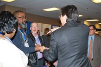 Magician David Hira (right) entertains school board members and other attendees at RossTarrant Architects’ booth at the Trade Show. Sixty-four exhibitors were on hand for the annual conference.
