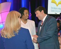 Education Commissioner Stephen Pruitt talks with Warren Central High School Advanced Chorus conductor Chandel Shanklin and KSBA Board Team Development Director Kerri Schelling.