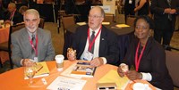 l-r, President elect David Webster of Simpson County, President Allen Kennedy of Hancock County and Director at Large Ramona Malone of Newport Independent used electronic clickers to cast their votes during the Delegate Assembly.