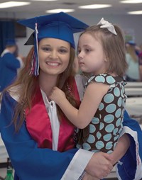 The day began with a family breakfast in a packed Adair County High. Then, seniors such as Haley Cromwell  (pictured with little sister, Haven, a member of the Adair County kindergarten Class of 2017) quickly dressed in their caps and gowns to hit the road. Organizers also used the event to get everyone together for the official graduating class picture at the end of the traveling “thank you” show.