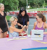 Anchorage Independent School Superintendent Kelley Ransdell (center standing) had to set aside time as host-in-chief to make a cash run for ticket table workers Geron Cadden, Laura Zachariah and Skye Tarr. This is the fourth year for the picnic, one of a series of annual fundraisers helping finance an eighth-grade trip to a marine exploration camp at the end of the year.