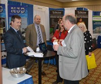 Russellville Independent board member INSERT NAME visits representatives of N3D Group Consulting Engineering and Planning of Lexington. More than 70 vendors had displays at the sold-out Trade Show.