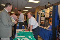 Tom Underwood, right, executive director of the Kentucky Propane Education & Research Council, talks to a conference attendee at the company’s Trade Show booth.