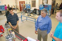 Robotics program students Jacob Harrison (left) and Leo Wiley show State Rep. Steve Riley (R-Glasgow