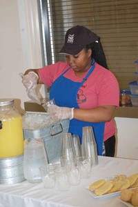 Diamond Beachamp, a culinary arts student, prepares drinks for the visitors’ meal of buffalo chicken