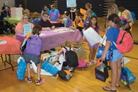 After getting clothes at the yard sale and the backpack with school supplies, families went to the gymnasium where about two dozen organizations, including the Trimble County public library, were on hand to provide information to parents. 