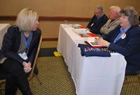 Grant County board member Lisa Smith, left, talks to Adair County Superintendent Pamela Stephens dur