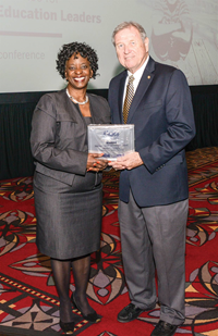 Newport Independent board chair Ramona Malone accepts a Magna Award, NSBA’s highest honor, on behalf