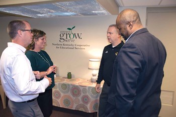 From left, Dayton Ind. Superintendent Jay Brewer, NKCES Executive Director Amy Razor, Bellevue Ind. Superintendent Robb Smith and Covington Ind. Superintendent Alvin Garrison talk after the co-op’s September meeting.