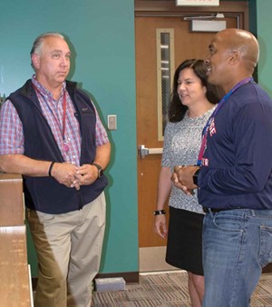 Charlie Bryant (left), facilities director for Anchorage Independent Schools, talks with Superintendent Kelley Ransdell and Principal Andrew Terry. All three said educating students and staff about the importance of energy savings has made a difference.