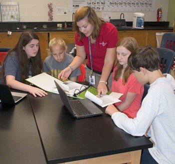 Anchorage students talk to teacher Raechel Minor. The students are members of the school’s STEM Club, which made energy awareness its focus last school year..