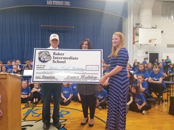 Kentucky Honor Flight representative accepting a $2,000 check from Clark County’s Baker Intermediate  School students