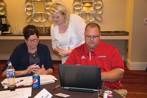 Mercer County school board Chair Marianne Davis and Superintendent Dennis Davis look over district data during the daylong session to launch the KSBA Gap Closure Project, with help from KDE novice reduction coach Wanetta Morrow.
