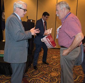 David Wickersham, left, who heads the Office of Education Accountability, talks with Harrison County board member Gary Dearborn following his clinic session at Summer Leadership Institute.