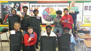 Health education and Sources of Strength Club students at Butler Traditional High School hold up “thank you” cards that identify the positive adult mentors and friends in their life as part of a Sources of Strength event. (Photo: Butler Traditional HS)