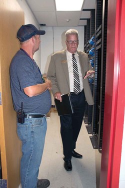 School safety assessment team member Chuck Fleischer (right) evaluates an equipment storage area at Nelson County High School with daytime custodian David Coulter. Fleischer is the retired Jefferson Co. Schools safety and environmental services director.