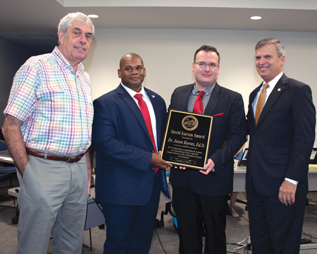 KBE named Jason Reeves, second from right, as the recipient of the David Karem Award. Presenting the award were, from left, former KBE member and state legislator David Karem, Commissioner of Education Wayne Lewis and KBE Chairman Hal Heiner.