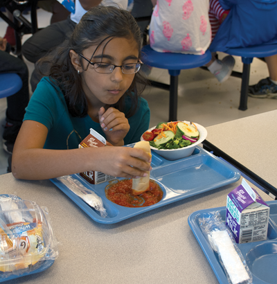 Tolliver Intermediate student Mahi Patel enjoys the freshly made marinara sauce and a salad topped with peppers and tomatoes from Overman’s Bluegrass Fruits and Vegetables. 