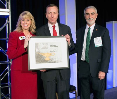 KSBA Executive Director Kerri Schelling, left, and KSBA President David Webster, right, present Bullitt County Superintendent Keith Davis with the 2018 F.F. Dupree Outstanding Superintendent Award.