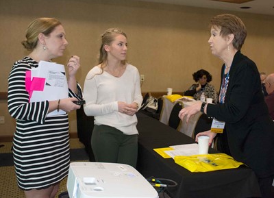 Raceland-Worthington Ind. school board member Sandra Loperfido, right, talks with (l-r) Heather Wendling and Morgan Powell with the National Association of Charter School Authorizers during a break at a three-hour pre-conference session.