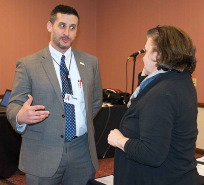 Chris McIntyre, CFO/treasurer for Warren County Schools, talks to Woodford County board member Debby Edelen at the KSBA Annual Conference.