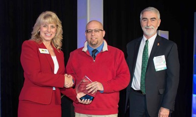 KSBA Executive Director Kerri Schelling, left, and President David Webster, chairman of the Simpson County Board of Education, presented the 2018 KSBA Friend of Education Award to Jamie Johnson of Gallatin County. 