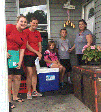 Newport Independent teachers Holly Owens and Elle Ventre visit with Dottie Farrell and students Keegan Farrell and Addison Wright as part of the district’s Home Visit Program. (Photo courtesy of Newport Independent Schools)