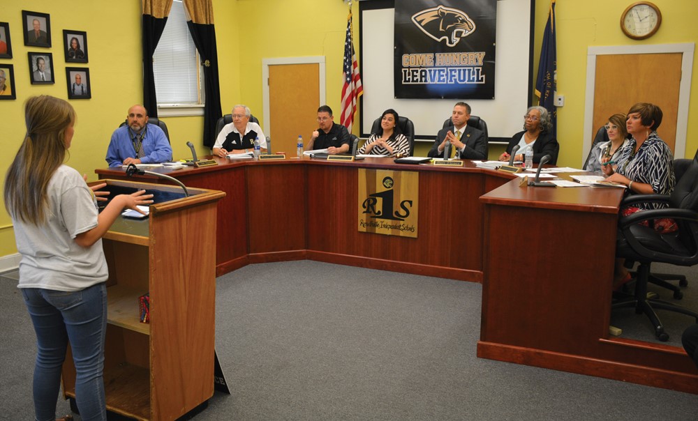 Russellville Independent High School senior Luci Suiter gives her panel review presentation to local business leaders, district administrators and a board member.