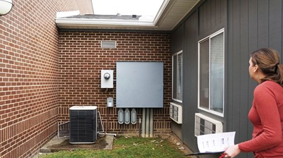 Project manager and architect Allison Commings with Sherman Carter Barnhart Architects looks at exterior conditions as she assesses East Bernstadt School for entry into the Kentucky Facilities Inventory and Classification System.