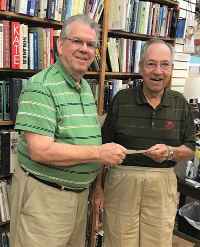 Caverna Independent school board Chairman Wayne Hatcher, left, accepts a $10,000 donation from Hart County native Don Redford.