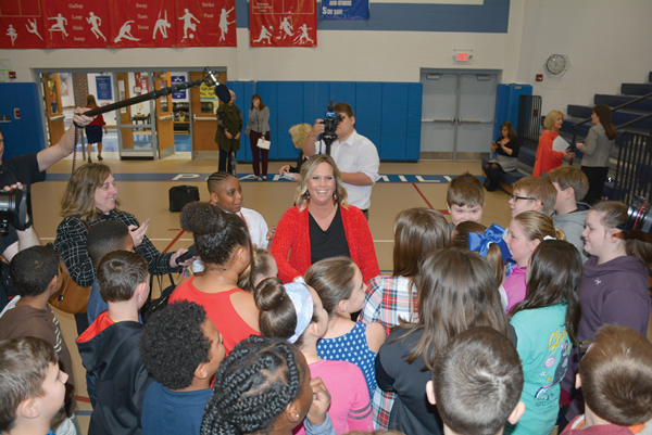 Angie Beavin’s students surround their teacher after the ceremony as television reporters from Louisville and Lexington ask her how it felt to win the Milken Award. 
