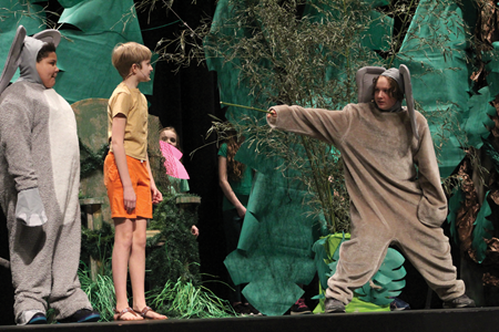 John W. Bate Middle School students (from left) Jasiah Nally, Sophie Wilson and Julius Lane act out a scene during the school’s production of “The Jungle Book” at the district’s Gravely Hall Performing Arts Center. 