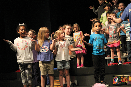 Students in Heather Gover’s kindergarten class at Mary G. Hogsett Primary School takes the stage at the district’s Performing Arts Center.