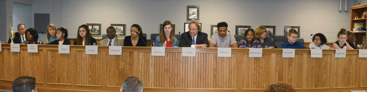 Paducah Independent school board members are joined by 10 students during March meeting