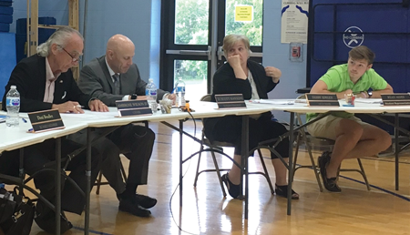 Woodford County High School junior Ryan Alvey, far right, listens during the district’s May meeting. Also pictured are Chairman Ambrose Wilson IV, Superintendent Scott Hawkins and Vice Chairwoman Debby Edelen.